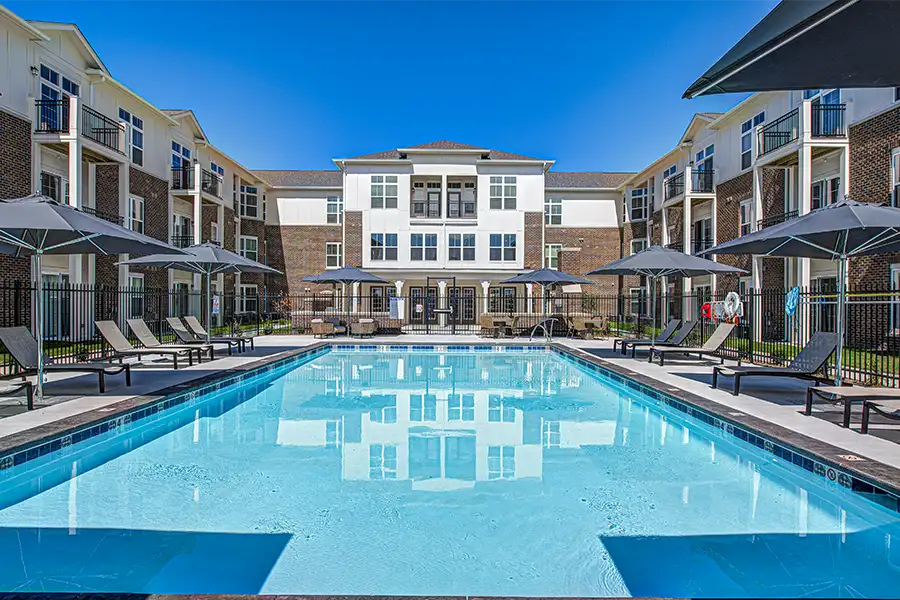 Not sure what a community means by amenities? This pool at The District Apartments is one example of an amenity. Pristine pool surrounded by apartment buildings at The District Apartments.